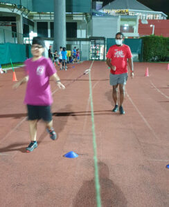 Running Straight - One big challenge in coaching athletics to people with visual impairment is helping them keep their lanes when racing. One technique Coach Sarav is working with our students is the use of the guide rope. The tether is hooked onto the guide rope that extends along the track lane for the distance (usually short, up to 100m).