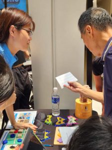 We had a range of fun activities catering to all ages (decode the code, a braille activity; tactile tic tac toe; picture search using handheld magnifier) to demonstrate how our students with visual impairment can access information and learn.
