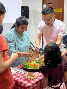 The event was lively with a traditional Lohei, where parents, kids, staff of iC2, and directors celebrated together, symbolizing unity and prosperity.