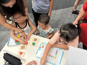 Visitors are engaging in activities such as solving various puzzles while blindfolded