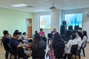 Teacher Lay Hong sharing her experiences as a parent of two accomplished para swimmers, Sophie and Colin, with 11 parents during a Parent Support Group session