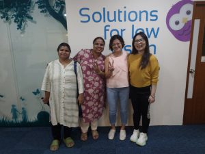 Four parents sharing smiles and support together