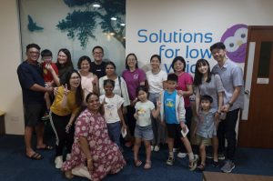 A group photo featuring parents, their children, and teacher Lay Hong