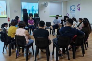 Teacher Lay Hong sharing her experiences as a parent of two accomplished para swimmers, Sophie and Colin, with 11 parents during a Parent Support Group session
