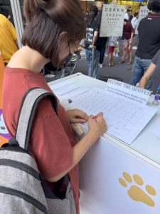 A visitor at iC2 booth takes on the challenge of decoding quotes using the Unified English Braille (UEB) chart