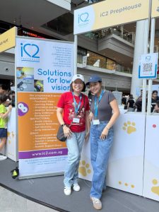 Two iC2 volunteers at the booth ready to engage with the community