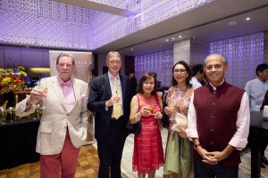 Guests enjoying lively conversations over canapés and drinks