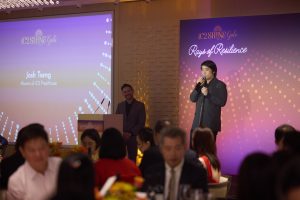 Alumnus Joshua Tseng delivering a heartfelt testimonial