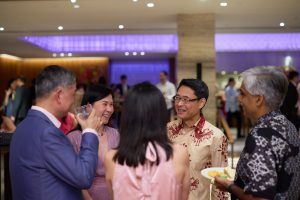 Guests enjoying lively conversations over canapés and drinks