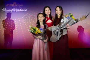 Dr Audrey Looi presents a bouquet of appreciation to Anisah and Stephanie.